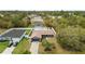 Aerial view of home with a driveway, palm tree, garage and well manicured lawn at 15690 Sw 46Th Cir, Ocala, FL 34473