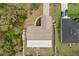 Aerial view of house with landscape, driveway, and two parked cars in the driveway at 15690 Sw 46Th Cir, Ocala, FL 34473