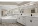 Bright bathroom featuring a garden tub, double sink vanity and great lighting at 15690 Sw 46Th Cir, Ocala, FL 34473
