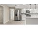 Bright kitchen with white cabinets, stainless steel appliances, and modern countertops at 15690 Sw 46Th Cir, Ocala, FL 34473