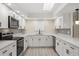 A well-lit kitchen featuring white cabinets, modern appliances, and stylish countertops at 15690 Sw 46Th Cir, Ocala, FL 34473