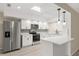 A modern kitchen with new white cabinets, stainless steel appliances, and a peninsula with seating at 15690 Sw 46Th Cir, Ocala, FL 34473
