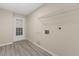 Bright laundry room features washer hook-ups, wire shelving and wood-look floors at 15690 Sw 46Th Cir, Ocala, FL 34473