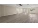 A large open living room with light wood floors and white walls, with natural light streaming in from outside at 15690 Sw 46Th Cir, Ocala, FL 34473