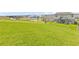 Expansive green backyard with view of home, nearby playground, and commercial buildings at 16013 Silver Brook Way Way, Winter Garden, FL 34787