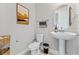 Modern half-bath with pedestal sink, decorative wall art, and stylish fixtures at 16013 Silver Brook Way Way, Winter Garden, FL 34787