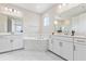 Elegant bathroom with dual vanities, marble accents, a soaking tub, and modern fixtures at 16013 Silver Brook Way Way, Winter Garden, FL 34787