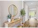 Elegant entryway with a decorative mirror, console table, and hardwood flooring at 16013 Silver Brook Way Way, Winter Garden, FL 34787