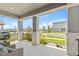 A covered front porch featuring stone columns, a seating area, and a view of the street at 16013 Silver Brook Way Way, Winter Garden, FL 34787