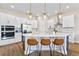 Bright kitchen with white cabinets, stainless steel appliances, quartz countertops, and stylish island seating at 16013 Silver Brook Way Way, Winter Garden, FL 34787