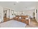 Spacious living room with a brown leather sofa and an open view to the kitchen at 16013 Silver Brook Way Way, Winter Garden, FL 34787