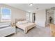 Spacious bedroom boasts natural light, plush carpet, and neutral palette with bed and closet access at 16013 Silver Brook Way Way, Winter Garden, FL 34787