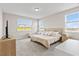 Bright main bedroom featuring neutral tones, plush carpeting, and large windows with picturesque views at 16013 Silver Brook Way Way, Winter Garden, FL 34787