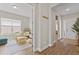 Open playroom with a large window, sofa, and a view of the front entryway at 16013 Silver Brook Way Way, Winter Garden, FL 34787