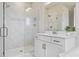 Contemporary bathroom featuring walk-in shower with glass enclosure, and sleek white vanity with modern fixtures at 16013 Silver Brook Way Way, Winter Garden, FL 34787