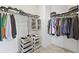 Well-organized walk-in closet with shelves, hanging rods, and ample storage space for clothes and accessories at 16013 Silver Brook Way Way, Winter Garden, FL 34787