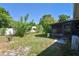 View of a backyard and enclosed porch featuring some plants and a white wooden fence at 1732 Oasis Ave, Deltona, FL 32725