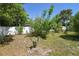 View of a backyard featuring a garden with different plants and a white wooden fence at 1732 Oasis Ave, Deltona, FL 32725