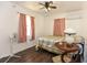 Bedroom with hardwood floors, vintage lamp, and pink curtains at 1732 Oasis Ave, Deltona, FL 32725