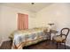 Bedroom with hardwood floors, vintage lamp, and pink curtains at 1732 Oasis Ave, Deltona, FL 32725