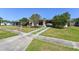 Single-story home with a driveway and walkway with plants and green lawn at 1732 Oasis Ave, Deltona, FL 32725