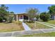 Charming single-story home with a walkway lined with beautiful plants and a driveway at 1732 Oasis Ave, Deltona, FL 32725