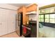 Galley kitchen with stainless steel refrigerator and access to screened porch at 1732 Oasis Ave, Deltona, FL 32725