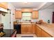 Traditional kitchen with light wood cabinets, neutral countertops and tile floor at 1732 Oasis Ave, Deltona, FL 32725
