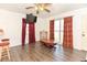 Comfortable living space featuring hardwood floors, natural light, and simple decor at 1732 Oasis Ave, Deltona, FL 32725