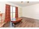 Bright living room featuring hardwood floors, a front-facing window, and a front door at 1732 Oasis Ave, Deltona, FL 32725