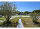 Relaxing street view in a residential neighborhood with well-maintained homes and green lawns at 1732 Oasis Ave, Deltona, FL 32725