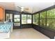 Enclosed sunroom featuring neutral tile flooring and a ceiling fan at 1732 Oasis Ave, Deltona, FL 32725