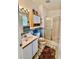 Bathroom featuring shower with glass door, white vanity and blue accents at 204 Holland St, Lake Wales, FL 33859