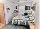 Comfortable bedroom featuring a decorative bedspread, dresser, and ample natural light at 204 Holland St, Lake Wales, FL 33859