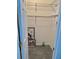 Walk-in closet featuring shelving and a carpeted floor with a decorative vase and framed picture at 204 Holland St, Lake Wales, FL 33859