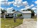 Charming single story home featuring a manicured lawn and attached garage, offering comfort and convenience at 204 Holland St, Lake Wales, FL 33859
