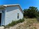 Exterior side view of a well-maintained home with vinyl siding and landscaping at 204 Holland St, Lake Wales, FL 33859