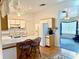 Open concept kitchen with breakfast bar, white cabinets, appliances, and a view into the cozy living room at 204 Holland St, Lake Wales, FL 33859