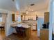 Bright kitchen features white cabinetry, breakfast bar with seating, and a door leading to the exterior at 204 Holland St, Lake Wales, FL 33859