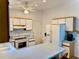 Efficient kitchen features white appliances, white cabinets, and an island with seating, offering a functional layout at 204 Holland St, Lake Wales, FL 33859
