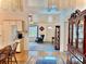 Open-concept living room with hardwood floors and a view of the entryway and kitchen at 204 Holland St, Lake Wales, FL 33859
