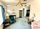 Bright living room featuring blue carpet and a variety of seating options at 204 Holland St, Lake Wales, FL 33859