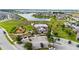 An aerial view of community amenities that include a pool, clubhouse, playground, parking, and lake at 2130 Bur Oak Blvd, St Cloud, FL 34771