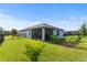 The backyard is spacious and has a screened in patio, black fence, and small trees planted at 2130 Bur Oak Blvd, St Cloud, FL 34771