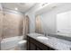 This bathroom features a granite countertop, tile flooring, and a shower-tub combo at 2130 Bur Oak Blvd, St Cloud, FL 34771