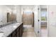 Bathroom featuring double vanity, tile shower, neutral walls with star decals, and natural lighting at 2130 Bur Oak Blvd, St Cloud, FL 34771