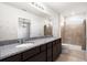 Bathroom featuring double vanity, tile shower, neutral walls with star decals, and natural lighting at 2130 Bur Oak Blvd, St Cloud, FL 34771