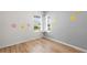 Bedroom with a large window and neutral walls with flower decals, and wood flooring at 2130 Bur Oak Blvd, St Cloud, FL 34771