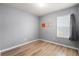 Cozy bedroom with wood flooring, neutral walls, and a large window at 2130 Bur Oak Blvd, St Cloud, FL 34771