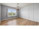 Bright bedroom with wood flooring, a large window, neutral walls, and modern lighting at 2130 Bur Oak Blvd, St Cloud, FL 34771